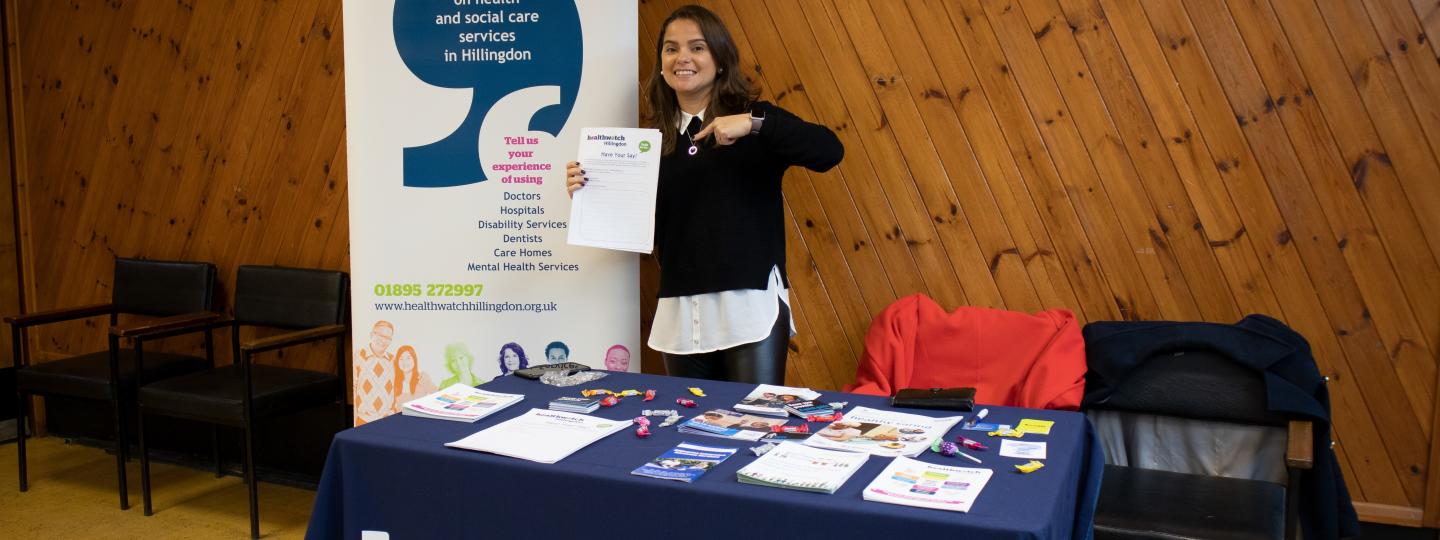Healthwatch Hillingdon volunteer holding a stall at an event
